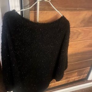 Black and it’s sparkles cape, sweater material great for the holidays